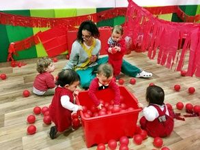  niños con maestra en fiesta de color rojo